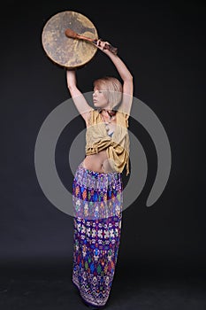 Modern Tribal Woman playing elk drum