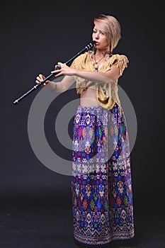 Modern Tribal Woman playing flute