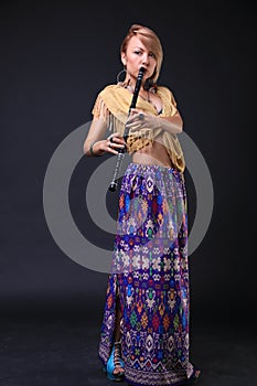 Modern Tribal Woman playing flute