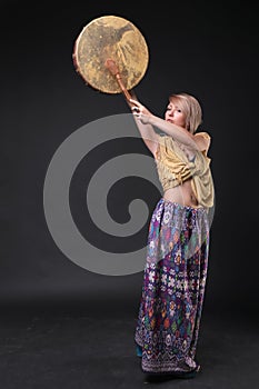 Modern Tribal Woman playing shaman drum