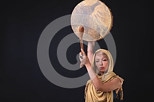 Modern Tribal Woman playing shaman drum