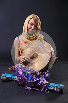 Modern Tribal Woman sitting with a drum