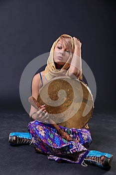 Modern Tribal Woman sitting with a drum