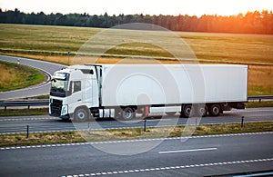 A modern truck with a refrigerator semi-trailer with refrigeration equipment transports flower products while