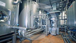 Modern unit of a distillery filled with steel canisters and pipes