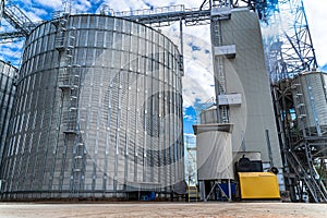 Modern up to date factory. Industrial agriculture elevators with harvested grain. Grain cooperative. Selective focus.