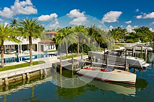 Modern upscale mansions in Miami Beach with yachts