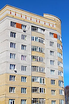 Modern urban architecture, rows of windows reflecting the sky.