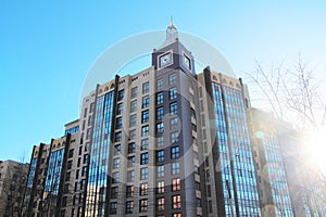 Modern urban architecture, rows of windows reflecting the sky.