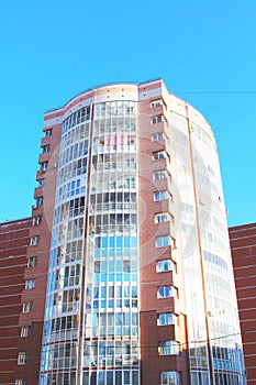 Modern urban architecture, rows of windows reflecting the sky.