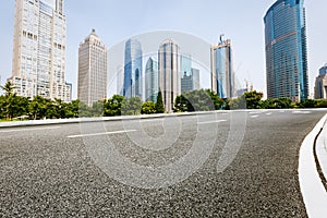 The modern urban commercial building and asphalt road