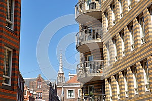 Modern urban development located on Calliopestraat in The Hague, with the clock tower of the german Evangelical Church