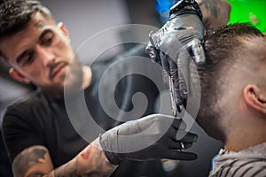 Modern urban hairdresser cut hair with hair scissors in professional hairdressing salon