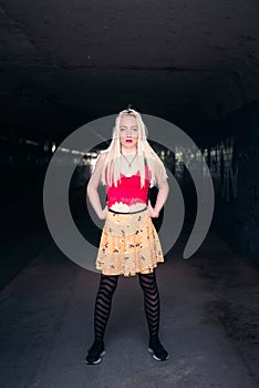 Modern urban hipster woman standing in tunnel