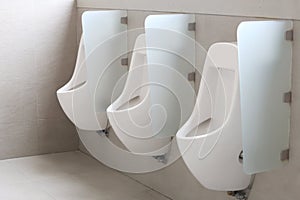 Modern urinal in men bathroom.