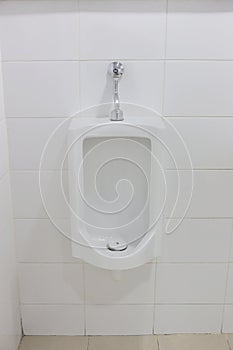 Modern urinal in men bathroom.