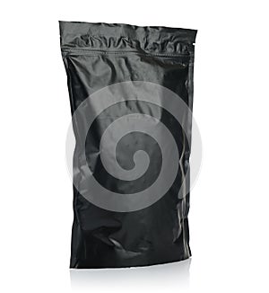 Modern vacuum sealed black package of coffee or tea photo