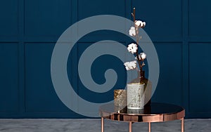 Modern Vases on metal copper side table in room with blue walls