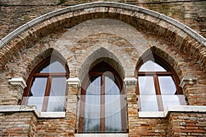 Modern Venetian-style houses with three-light Gothic windows. photo