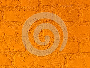 Modern vibrant orange stone brick wall with big bricks close up background pattern