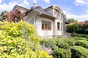 Modern villa exterior surrounded by garden