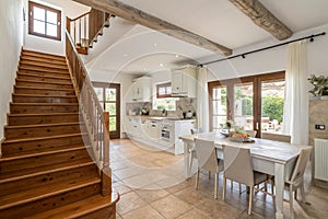 Villa with open dining room and white kitchen