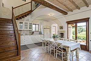 Villa with open dining room and white kitchen