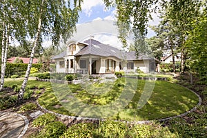 Modern villa housefront in the garden photo