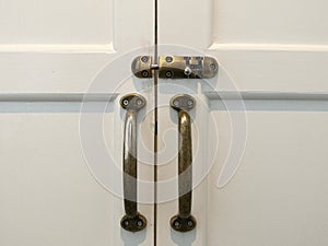 Modern vintage style door handle and slide lock on white natural wooden door, white door with lock and handle