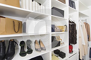 Modern walk in closet with luxury shoes and bags