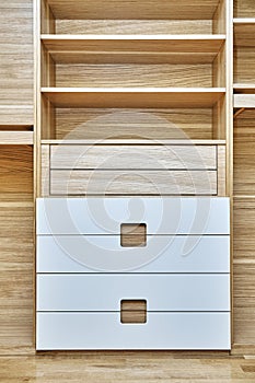 Modern wardrobe with finger pull design. Wooden wardrobe with light gray cabinet doors. Modern furniture