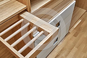 Modern wardrobe with slide out rack for coathangers. Detail of modern furniture