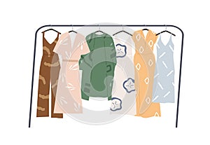 Modern wardrobe of summer clothing hanging on floor hanger rack. Casual women apparels. Collection of stylish garments