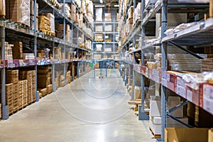 Modern warehouse with goods on collapsible metal shelves. Blurred, focus with shallow depth of field