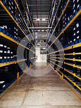 Modern warehouse within plastic boxes and the shelf stocking raw material