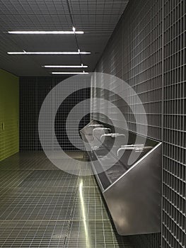 Modern washhouse of public toilets underground..Space designed with grids