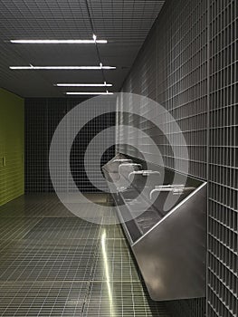 Modern washhouse of public toilets underground..Space designed with grids photo