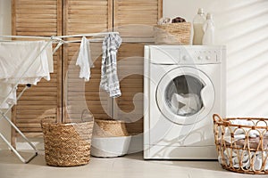 Modern washing machine in laundry room