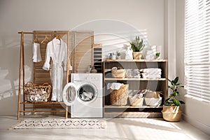 Modern washing machine and shelving unit in laundry room