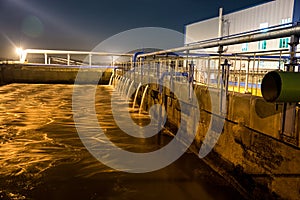 Modern wastewater treatment plant of chemical factory at night.