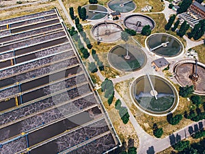 Modern wastewater treatment plant with round ponds for recycle dirty sewage water, aerial view from drone