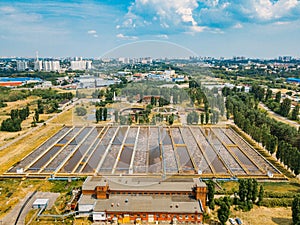 Modern wastewater treatment plant. Tanks for aeration and biological purification of sewage, aerial view from drone