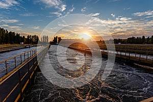 Modern wastewater treatment plant. Tanks for aeration and biological purification of sewage at sunset