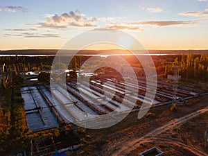 Modern wastewater treatment plant, tanks for biological purification of sewage, aerial view at the evening sunset