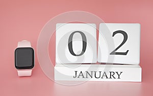 Modern Watch with cube calendar and date 02 january on pink background. Concept winter time vacation