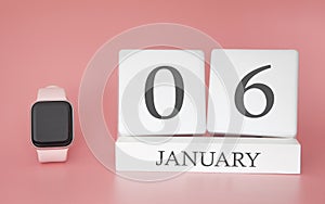 Modern Watch with cube calendar and date 06 january on pink background. Concept winter time vacation