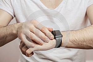 Modern watch on wrist isolated on a white background