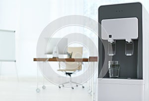 Modern water cooler with glass in office.