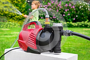 Modern water pump in garden on hot summer day