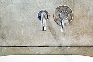 Modern water tap sink with faucet in minimalistic style in expensive loft bathroom